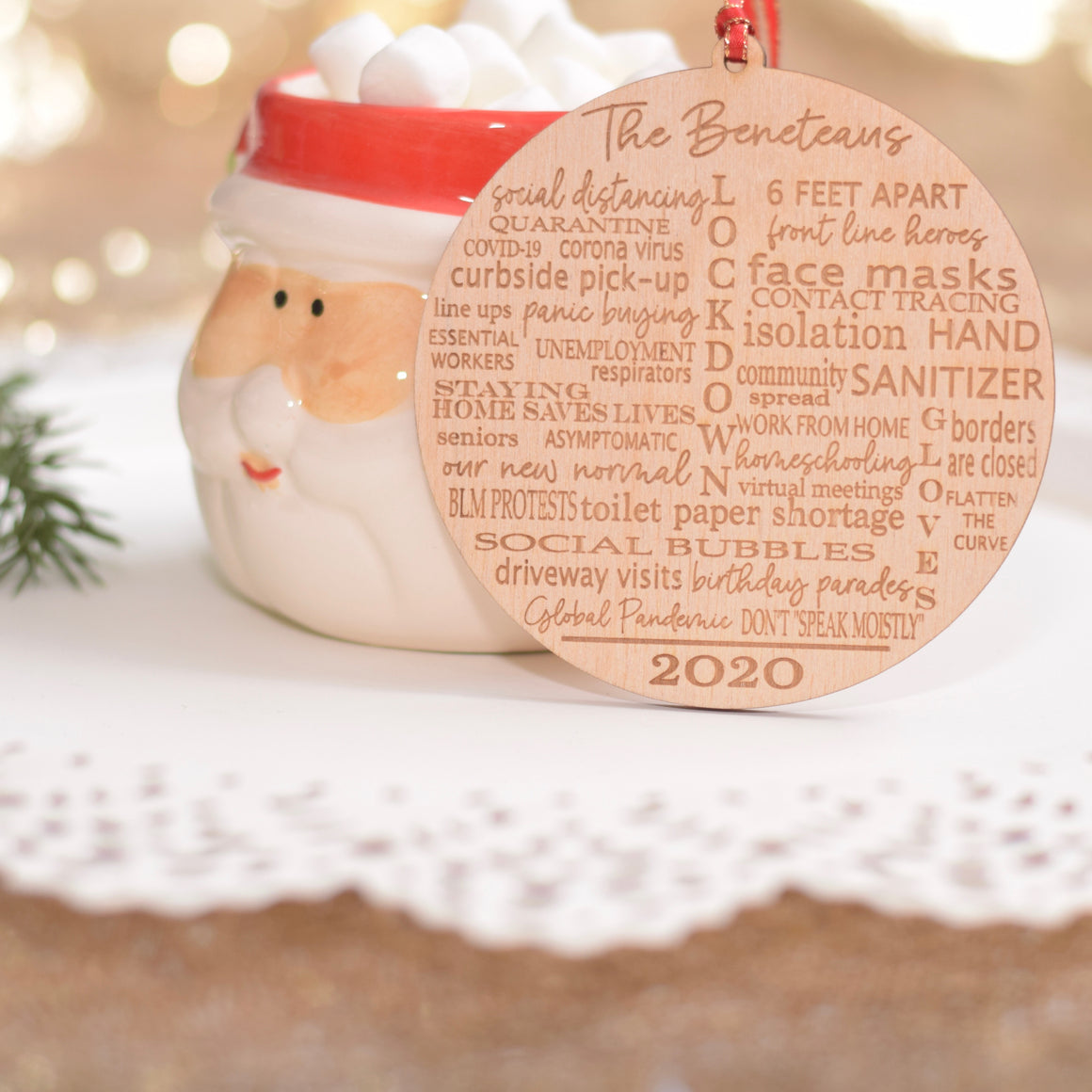 Wooden Quarantine Ornament resting on a Santa Christmas Mug