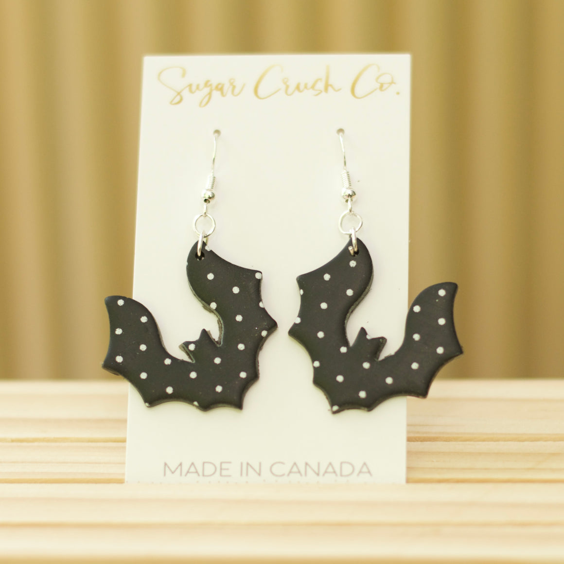 Cute black bat earrings with white polka dots, Halloween earrings handmade in Canada and available for wholesale