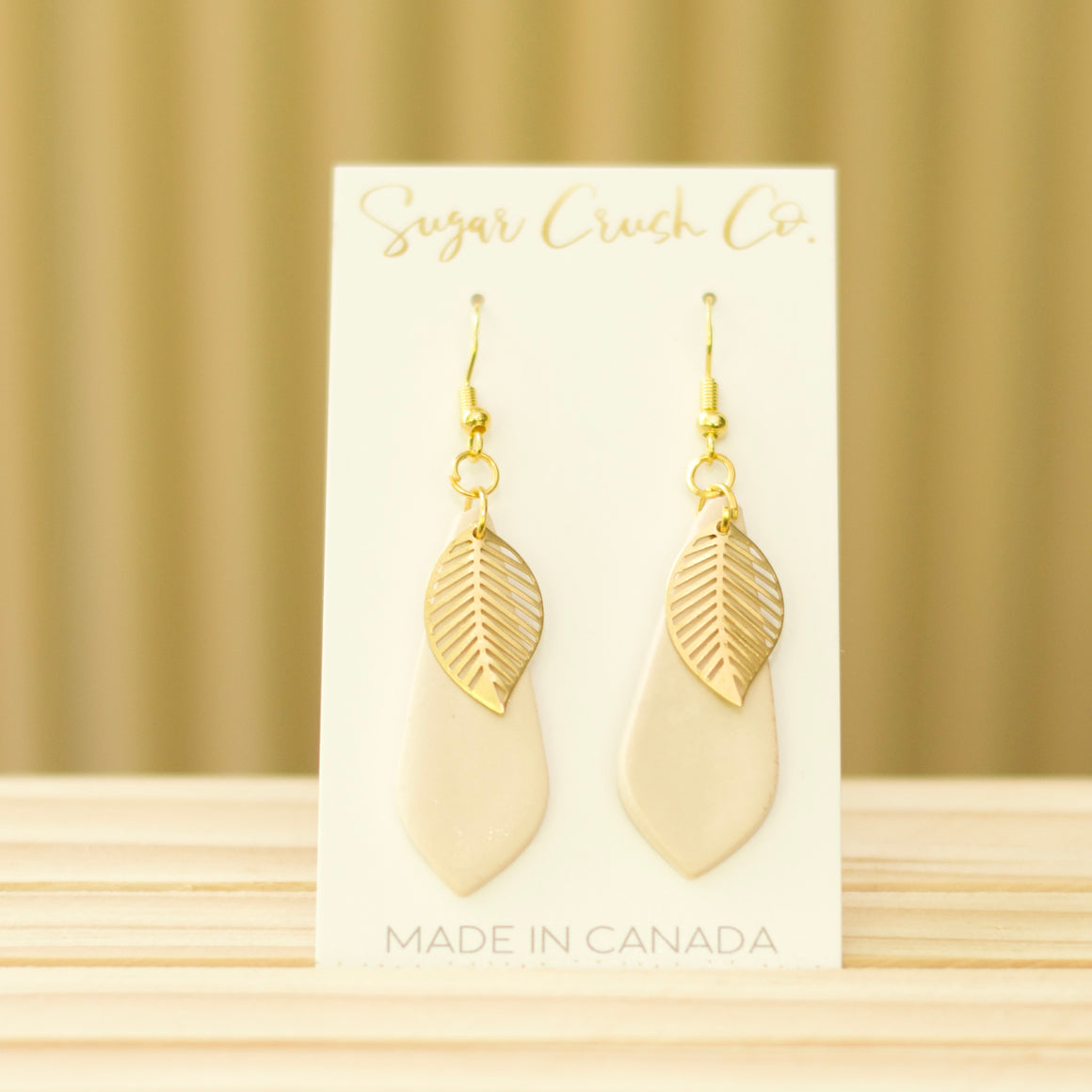 Fall earrings with a teardrop shape and a brass leaf. Handmade in Canada and wholesale is available.