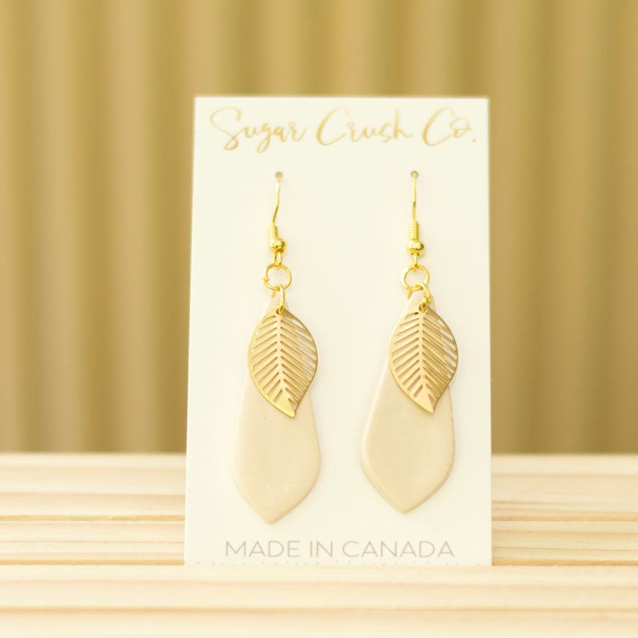 Fall earrings with a teardrop shape and a brass leaf. Handmade in Canada and wholesale is available.
