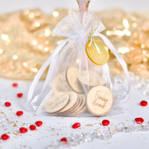 Date night tokens in a white organza bag ready for gifting on Valentine's Day