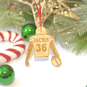 Football player Christmas gift on a white table with candy cane