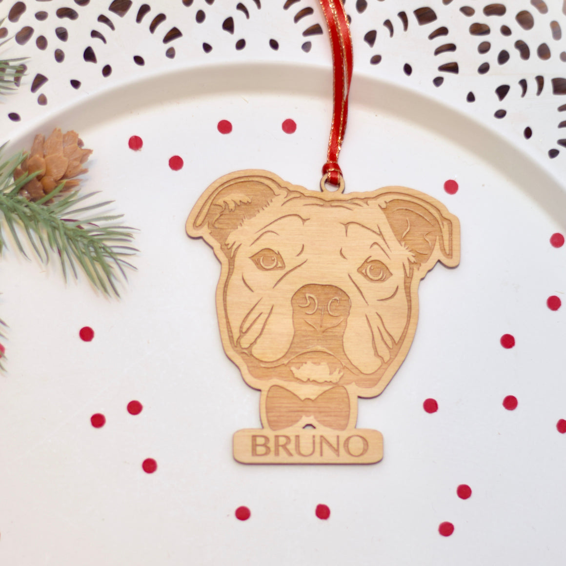 French bully ornament on a cake plate with red confetti