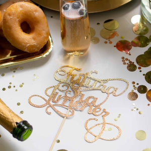 Gold Futura Señora cake topper on table with donuts and champagne
