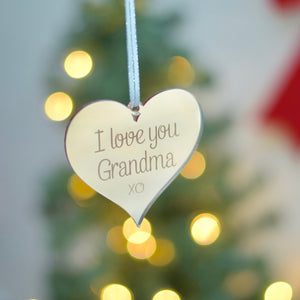 I love you Grandma ornament hanging in front of christmas tree with lights