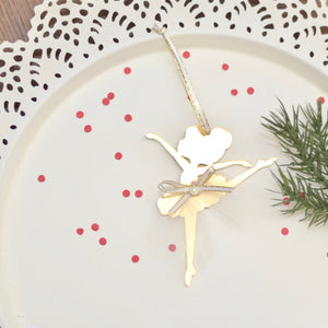 Gold Christmas Tree ornament with white tutu on a white cake plate