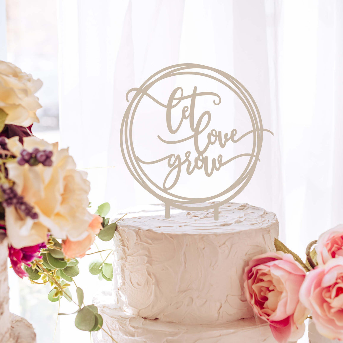 let love grow cake topper at a bridal shower with cake florals