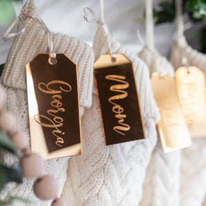 Gold acrylic stocking tags on white knit stockings