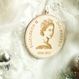 Side angle of the wooden Queen Elizabeth ornament to show the thickness of the wood. Displayed on a white lace wedding dress.