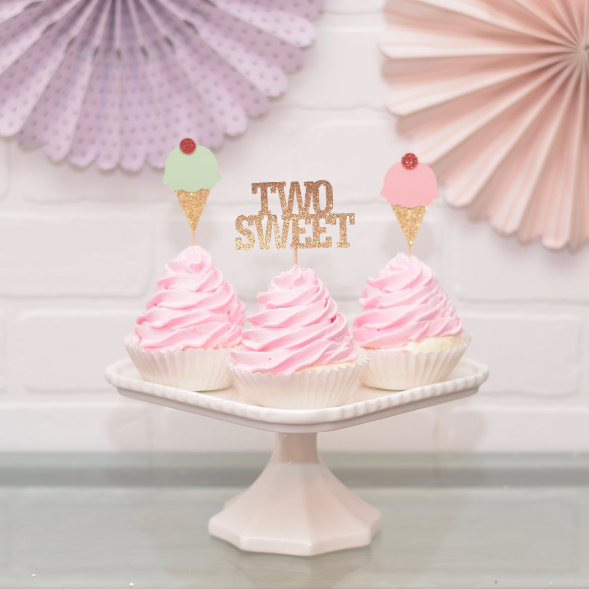 two sweet cupcake toppers on pink cupcakes