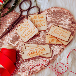 9 holiday gift tags on a sparkly pink stocking