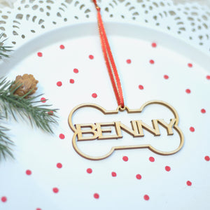 Benny Christmas tree ornament on a cake plate with greenery and red confetti