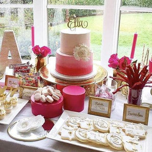 Ella cake topper on pink and gold sweets table