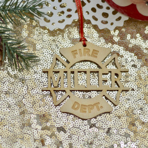 fireman ornament on a sparkly gold table cloth with Christmas greenery