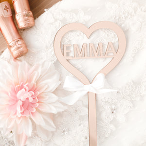Rose gold wand on a white wedding dress, pink flowers and champagne