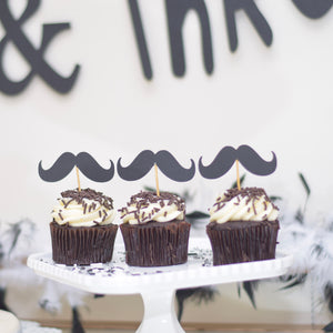 Set of three Black moustache cupcake toppers with three black and white cupcakes