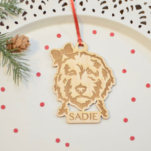Wooden Christmas ornament of golden doodle with bow in hair 