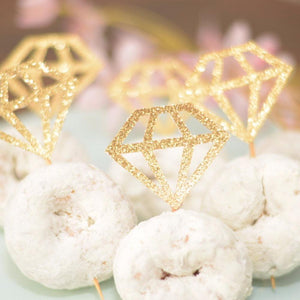 gold sparkly diamond ring in three powdered mini doughnuts