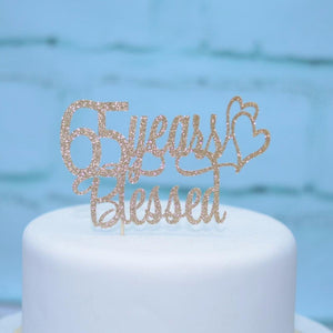 65 years blessed extra shiny glitter cake topper on white cake with blue background