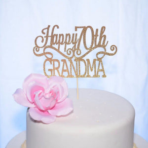 Happy 70th Grandma gold sparkle cake topper on white cake