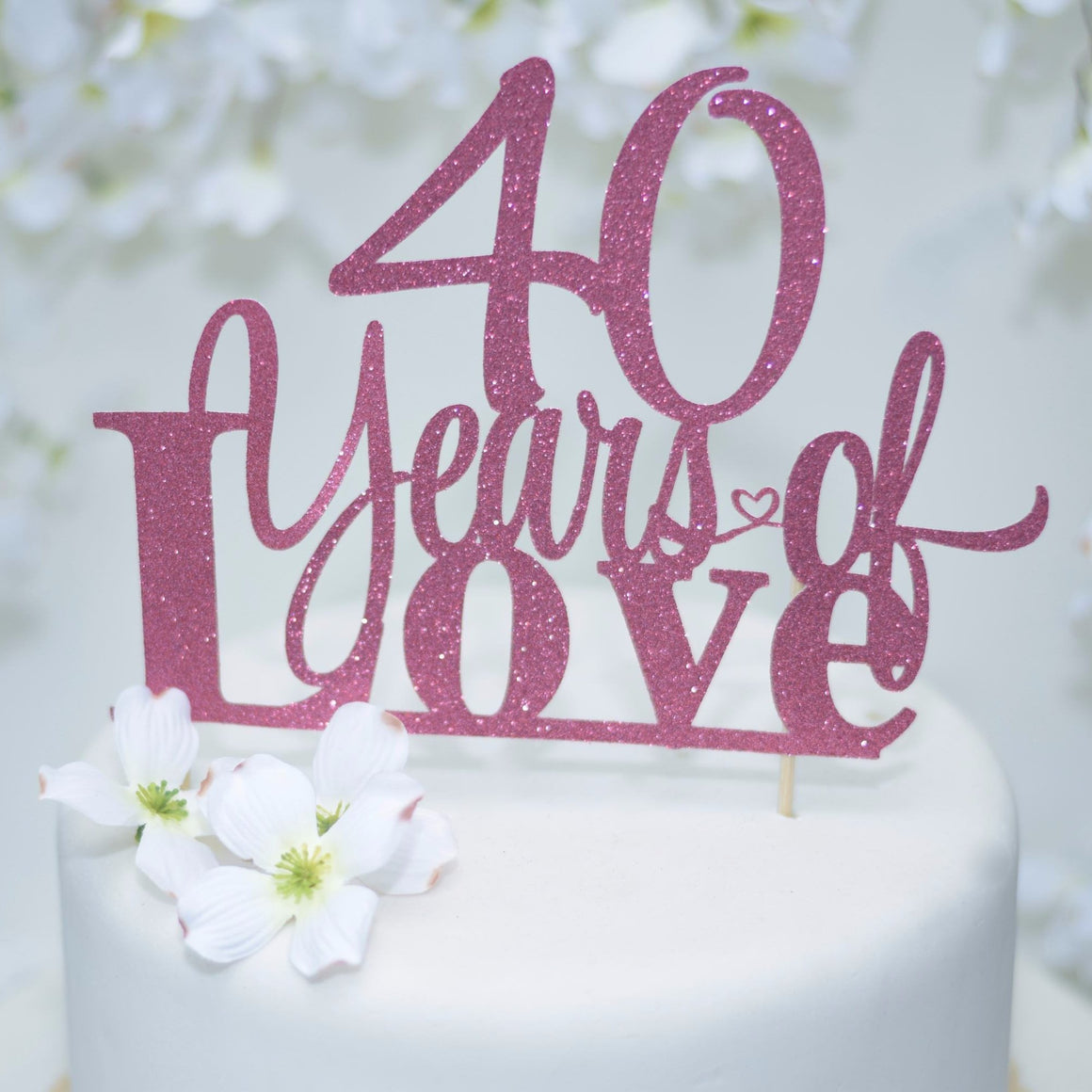 40 Years of Love gold sparkle cake topper with underline below Love on white cake 