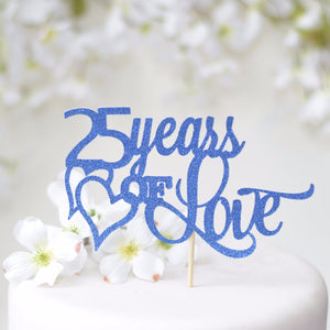 25 years of love with blue sparkles with two hears intertwined on white cake