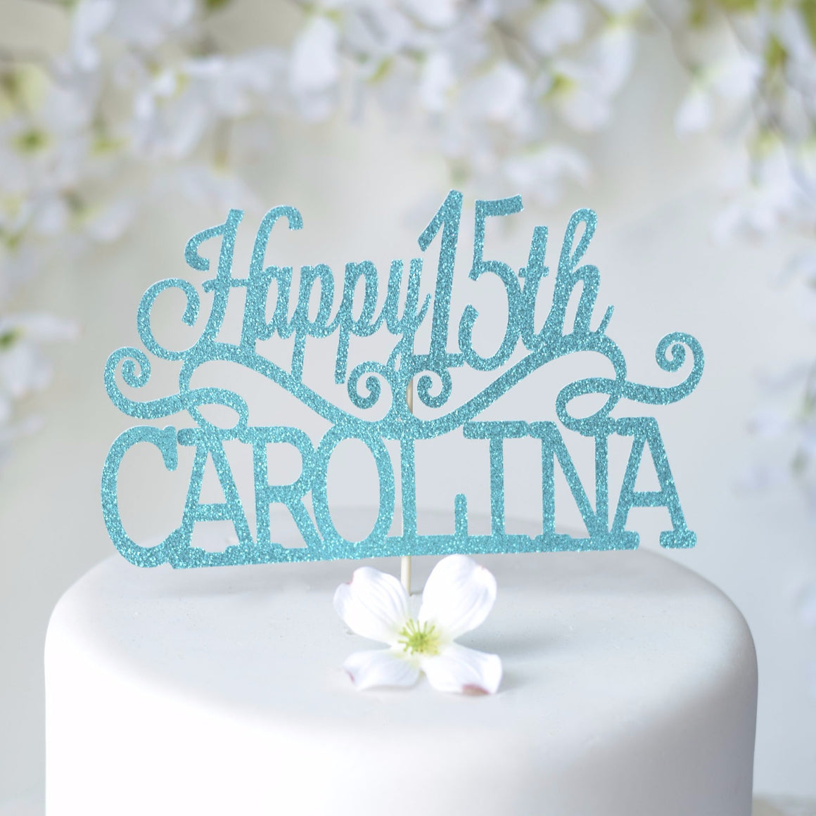 Happy 15th Carolina Quinceañera cake topper with blue and teal sparkles