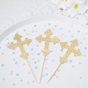 Gold Cross Cupcake toppers on a cake plate