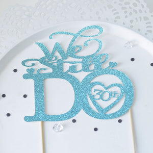 We Still Do 30th Wedding Anniversary cake topper on white background in light blue glitter font