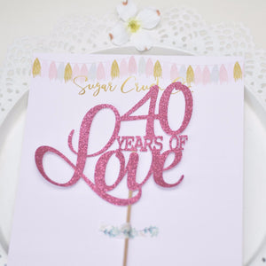 40 years of love pink cake topper on white plate