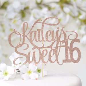 Kailey's sweet 16 rose gold cake topper on white cake with flower details