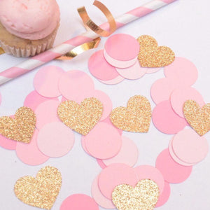 gold sparkly heart decorations with pink confetti