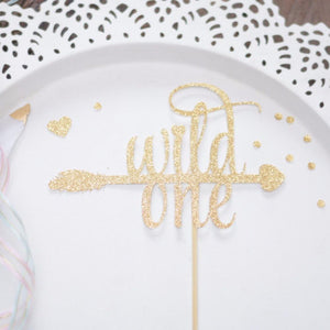 All gold sparkle cake topper that spells Wild One