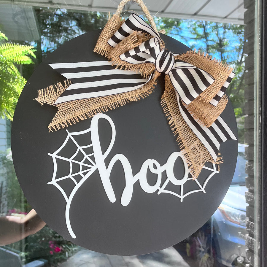 Black and white boo sign with a burlap and striped bow, perfect for fall and Halloween front door decor. 