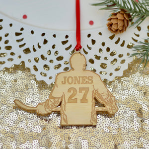 hockey jersey ornament made out of wood placed on gold sparkly table cloth